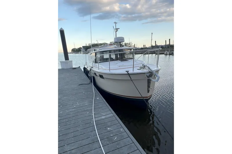 Anima Gemella Yacht Photos Pics 2023 Ranger Tugs R-27 docked at a marina under a partly cloudy sky.