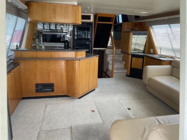  Yacht Photos Pics Interior of a 1998 Bayliner 4788 Pilot House Motoryacht with wood cabinetry and beige seating.