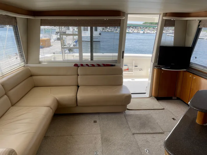 Yacht Photos Pics 1998 Bayliner 4788 Pilot House Motoryacht interior with beige leather seating and waterfront view.