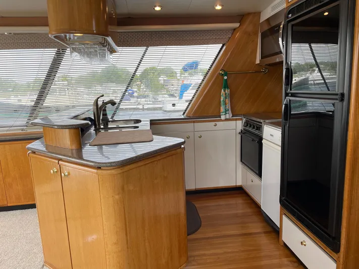  Yacht Photos Pics 1998 Bayliner 4788 Pilot House Motoryacht kitchen with wood cabinetry and modern appliances.
