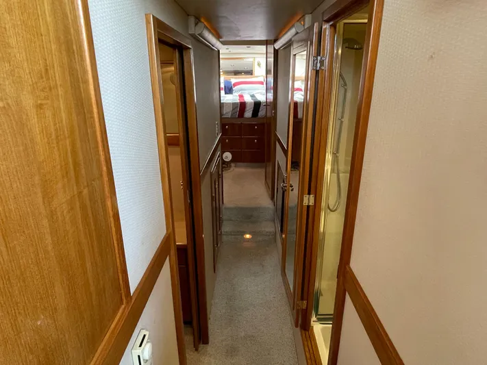  Yacht Photos Pics 1998 Bayliner 4788 Pilot House Motoryacht interior hallway with wood trim and carpet.