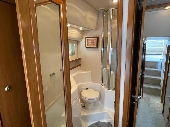  Yacht Photos Pics 1998 Bayliner 4788 Pilot House Motoryacht bathroom with shower and wooden accents.