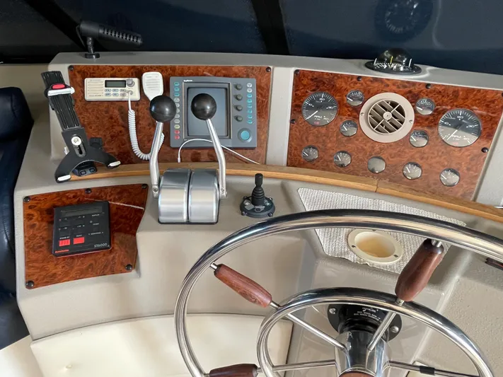  Yacht Photos Pics 1998 Bayliner 4788 Pilot House Motoryacht helm with navigation controls and steering wheel.