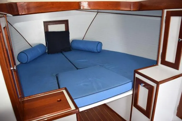 Rampage Yacht Photos Pics Open V-berth with filler cushion, wood trim