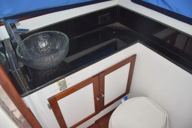 Rampage Yacht Photos Pics Head with granite vanity, backsplash, and basin sink