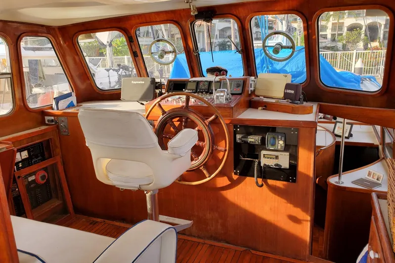  Yacht Photos Pics Interior of 1982 Cheoy Lee 52 yacht with wooden helm and navigation equipment.