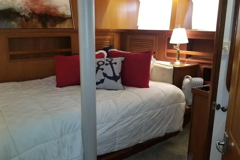  Yacht Photos Pics Cozy bedroom interior of 1982 Cheoy Lee 52 yacht with nautical-themed decor.
