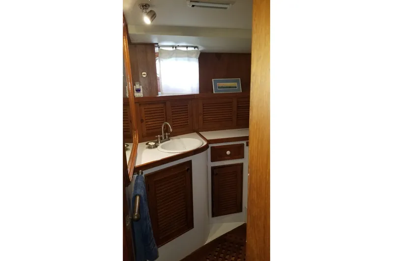  Yacht Photos Pics 1982 Cheoy Lee 52 yacht bathroom with wooden cabinetry and sink.