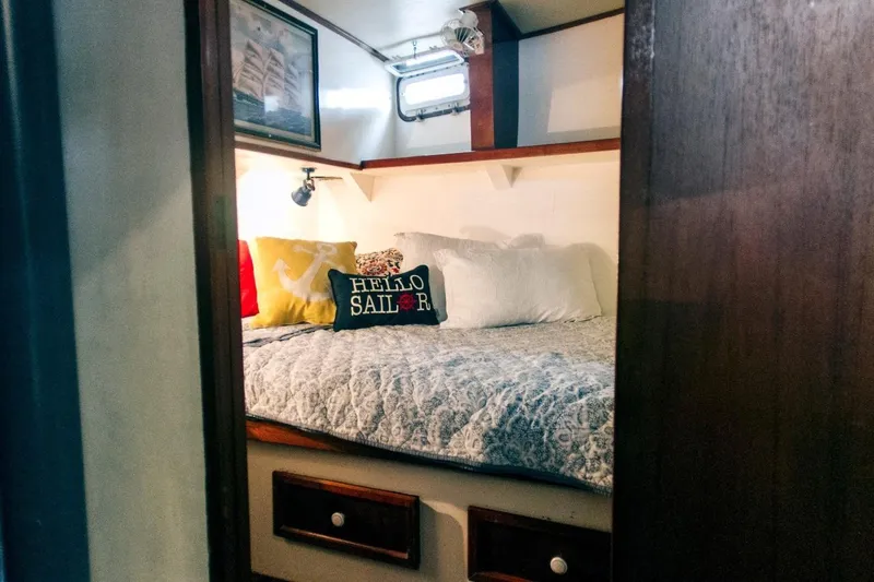  Yacht Photos Pics Cozy cabin interior of 1982 Cheoy Lee 52 yacht with nautical-themed decor.