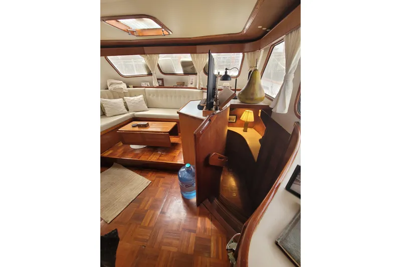  Yacht Photos Pics Interior of 1982 Cheoy Lee 52 yacht with cozy seating and wooden decor.