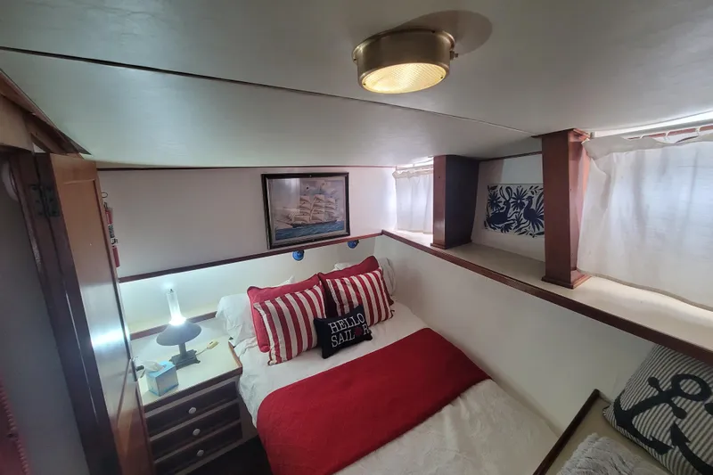  Yacht Photos Pics Cozy cabin interior of 1982 Cheoy Lee 52 yacht with nautical decor and bedding.