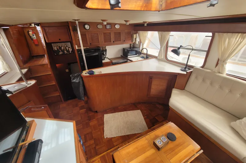  Yacht Photos Pics Interior of 1982 Cheoy Lee 52 yacht with wood finishes and cozy seating area.