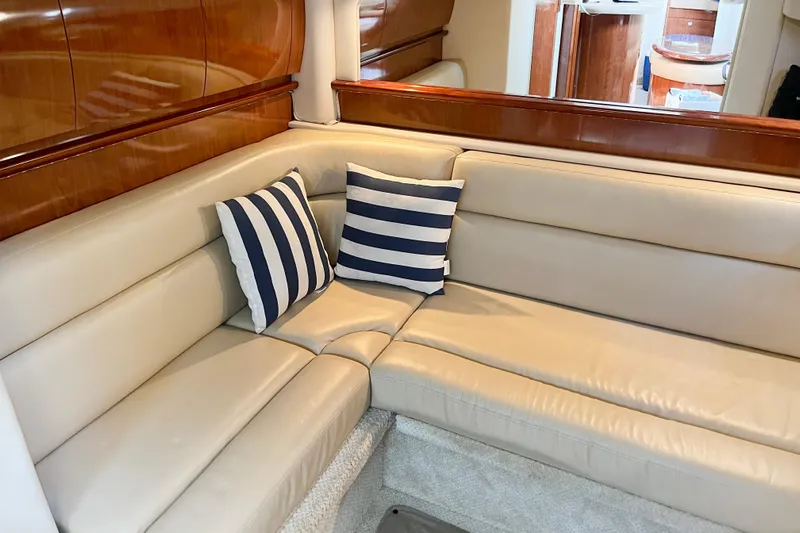  Yacht Photos Pics Luxurious interior of 2004 Searay 420 Sundancer with beige leather seating and striped cushions.