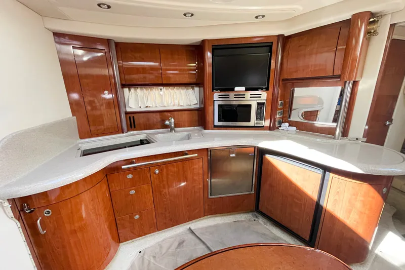  Yacht Photos Pics Luxurious 2004 Searay 420 Sundancer yacht kitchen with wood cabinetry and modern appliances.