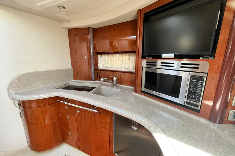  Yacht Photos Pics Luxurious 2004 Searay 420 Sundancer yacht kitchen with modern appliances and elegant wood cabinetry.