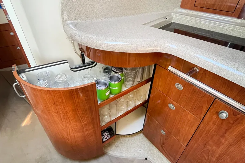  Yacht Photos Pics 2004 Searay 420 Sundancer yacht interior with wooden cabinetry and glass storage.