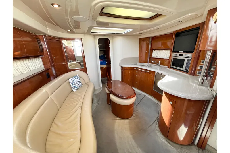  Yacht Photos Pics Luxurious interior of 2004 Searay 420 Sundancer yacht with elegant seating and modern kitchen.
