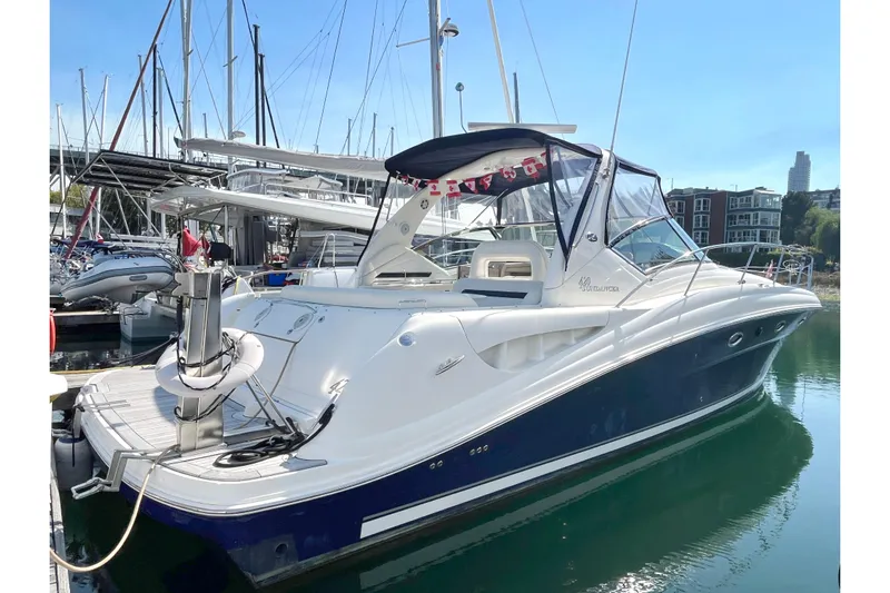  Yacht Photos Pics 2004 Searay 420 Sundancer yacht docked in marina, featuring sleek design and blue hull.