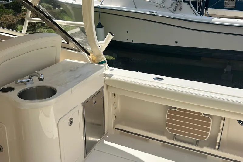  Yacht Photos Pics 2020 Grady-White Freedom 307 boat interior with sink and storage area.