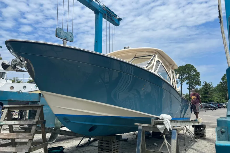  Yacht Photos Pics 2020 Grady-White Freedom 307 boat on dry dock under blue sky.
