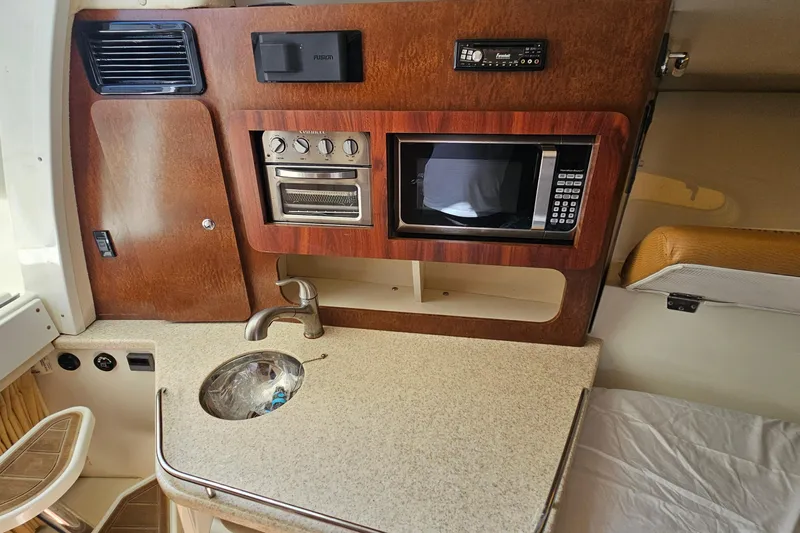  Yacht Photos Pics 2008 Hydra-Sports Vector 3500 VX cabin kitchen with sink, microwave, and wooden cabinetry.