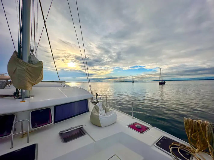 Road Less Travelled Yacht Photos Pics Lagoon 421 catamaran sailing at sunset on calm waters, 2013 model.