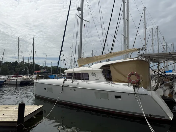 Road Less Travelled Yacht Photos Pics 2013 Lagoon 421 catamaran docked at a marina with other sailboats.