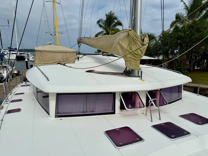 Road Less Travelled Yacht Photos Pics 2013 Lagoon 421 catamaran docked, featuring a sleek white deck and covered sails.