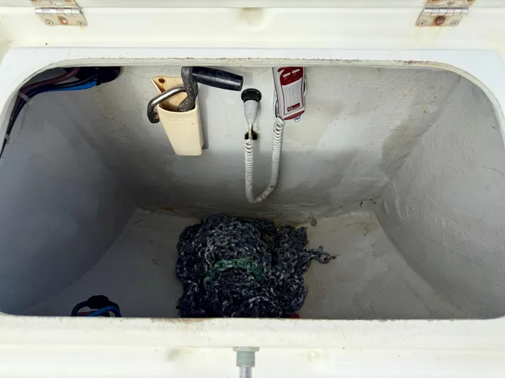 Road Less Travelled Yacht Photos Pics Storage compartment of a 2013 Lagoon 421 boat with coiled rope and tools.