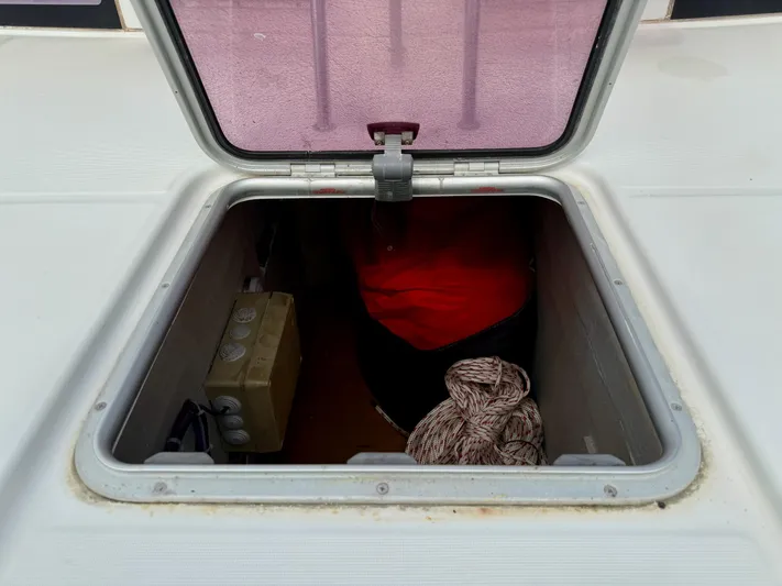 Road Less Travelled Yacht Photos Pics Open hatch on 2013 Lagoon 421 catamaran, showing storage compartment with rope and equipment.