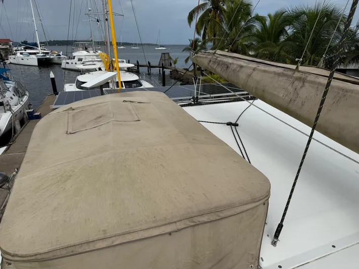 Road Less Travelled Yacht Photos Pics 2013 Lagoon 421 catamaran docked at marina with palm trees and sailboats.