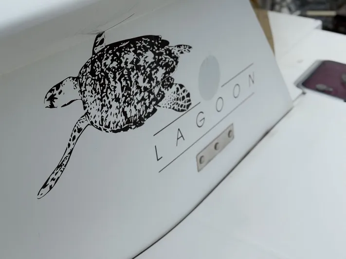 Road Less Travelled Yacht Photos Pics 2013 Lagoon 421 boat logo featuring a turtle design on white surface.
