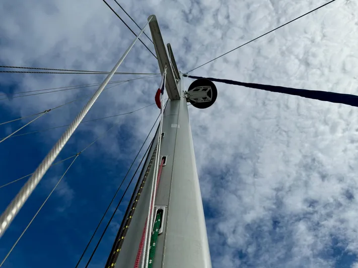Road Less Travelled Yacht Photos Pics Mast of 2013 Lagoon 421 sailboat against a cloudy sky.