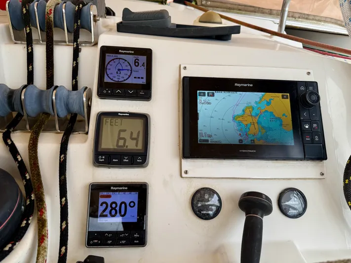 Road Less Travelled Yacht Photos Pics Control panel of a 2013 Lagoon 421 catamaran with navigation instruments and map display.