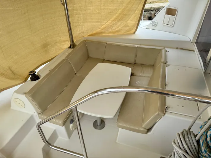 Road Less Travelled Yacht Photos Pics Cozy seating area on 2013 Lagoon 421 catamaran with beige cushions and table.