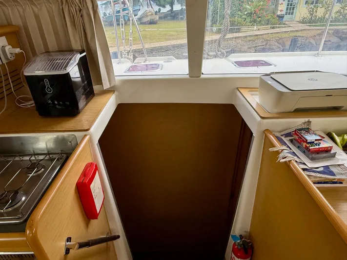 Road Less Travelled Yacht Photos Pics Interior of 2013 Lagoon 421 yacht with kitchen appliances and a view outside.