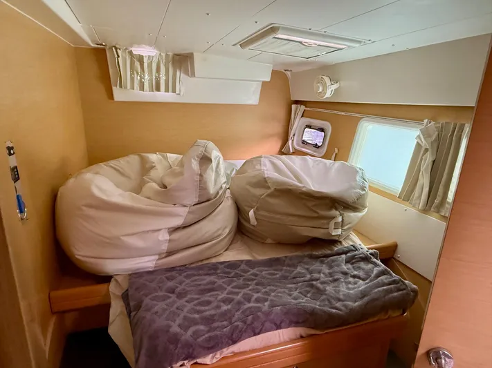 Road Less Travelled Yacht Photos Pics Cozy cabin interior of 2013 Lagoon 421 catamaran with bean bags and window view.
