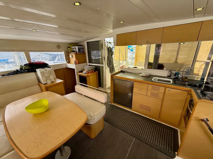 Road Less Travelled Yacht Photos Pics Interior of 2013 Lagoon 421 catamaran with kitchen and dining area.