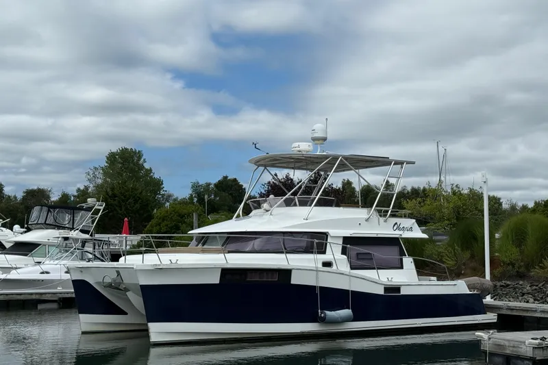 Ohana Yacht Photos Pics 2015 Fountaine Pajot Summerland 40 LC catamaran docked at marina under cloudy sky.