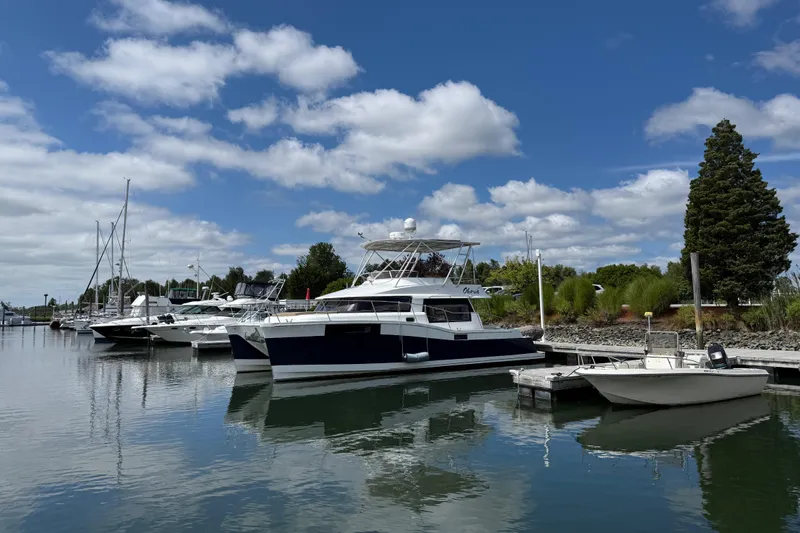 Ohana Yacht Photos Pics 2015 Fountaine Pajot Summerland 40 LC catamaran docked at a marina under blue skies.