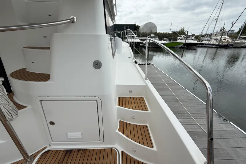 Ohana Yacht Photos Pics 2015 Fountaine Pajot Summerland 40 LC yacht docked, featuring teak steps and stainless steel railings.