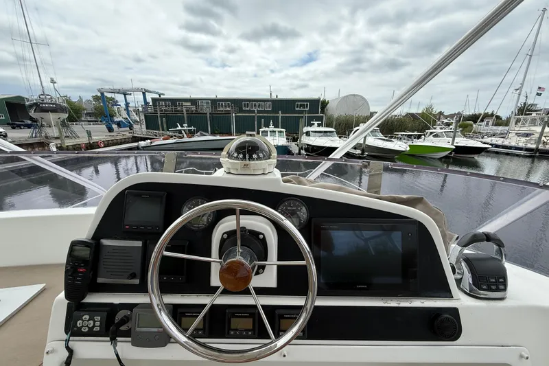 Ohana Yacht Photos Pics Helm of 2015 Fountaine Pajot Summerland 40 LC with marina view in background.