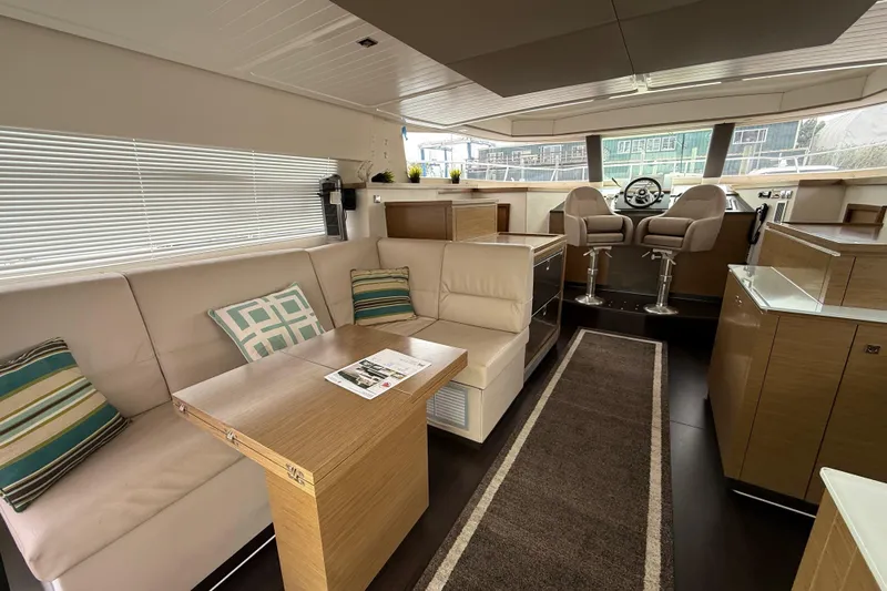 Ohana Yacht Photos Pics Luxurious interior of 2015 Fountaine Pajot Summerland 40 LC yacht with modern seating and helm.