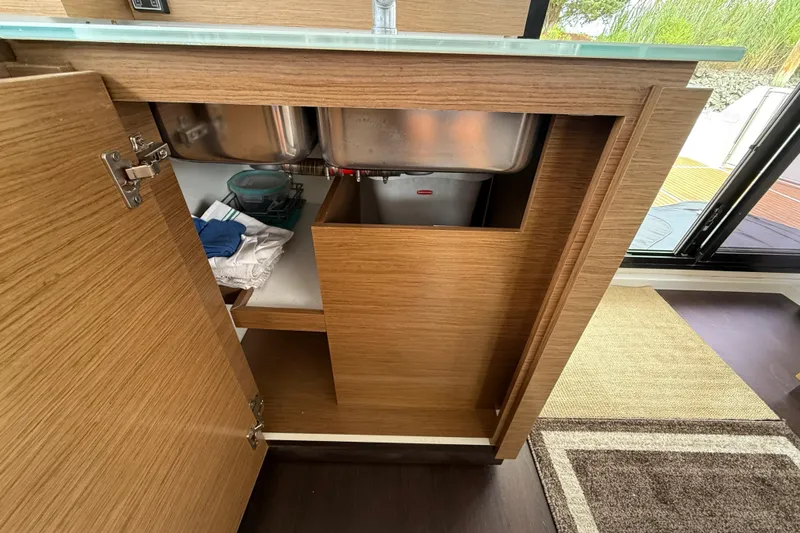Ohana Yacht Photos Pics Interior view of 2015 Fountaine Pajot Summerland 40 LC kitchen cabinet with open doors.