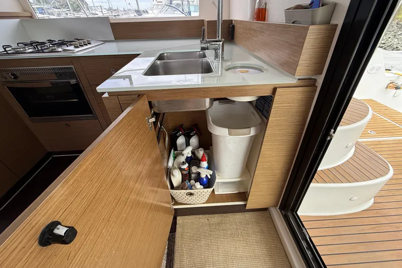 Ohana Yacht Photos Pics Modern kitchen on 2015 Fountaine Pajot Summerland 40 LC yacht with open cabinet storage.