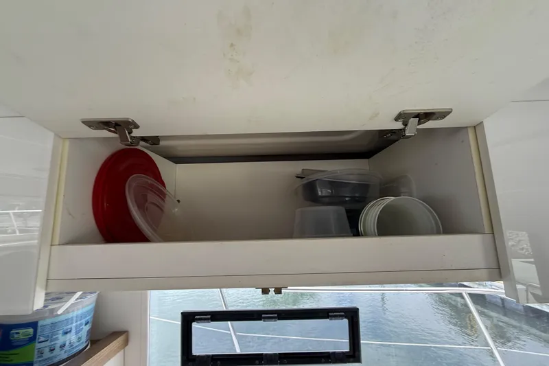Ohana Yacht Photos Pics Open cabinet with plastic containers on Fountaine Pajot Summerland 40 LC, 2015 model.
