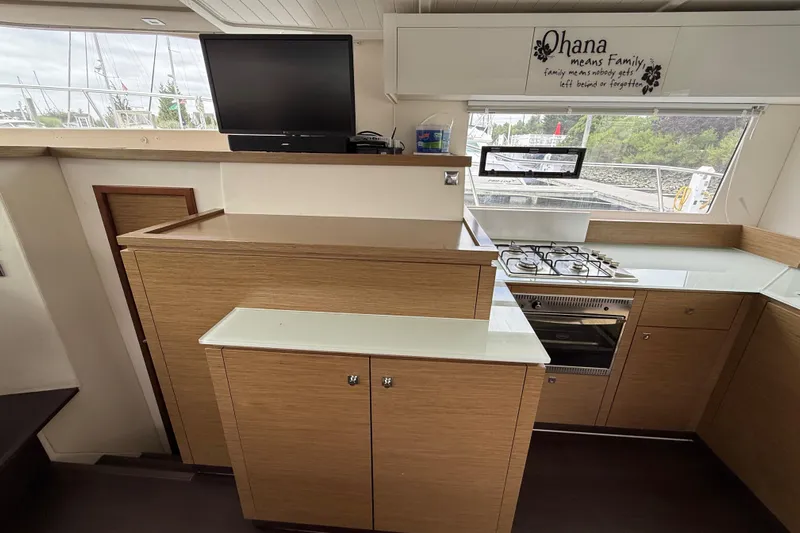Ohana Yacht Photos Pics Interior of 2015 Fountaine Pajot Summerland 40 LC yacht kitchen with stove and TV.