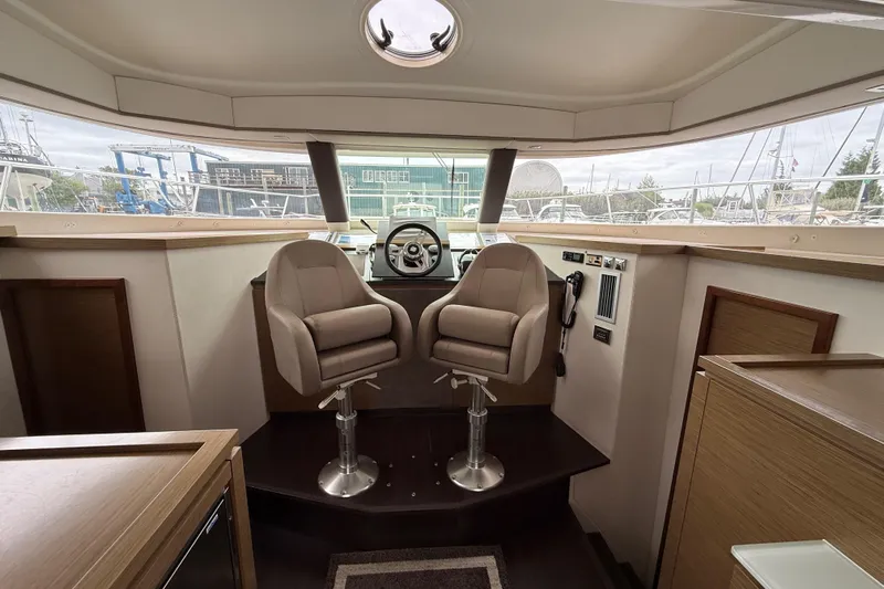 Ohana Yacht Photos Pics Interior helm of 2015 Fountaine Pajot Summerland 40 LC with dual captain chairs.