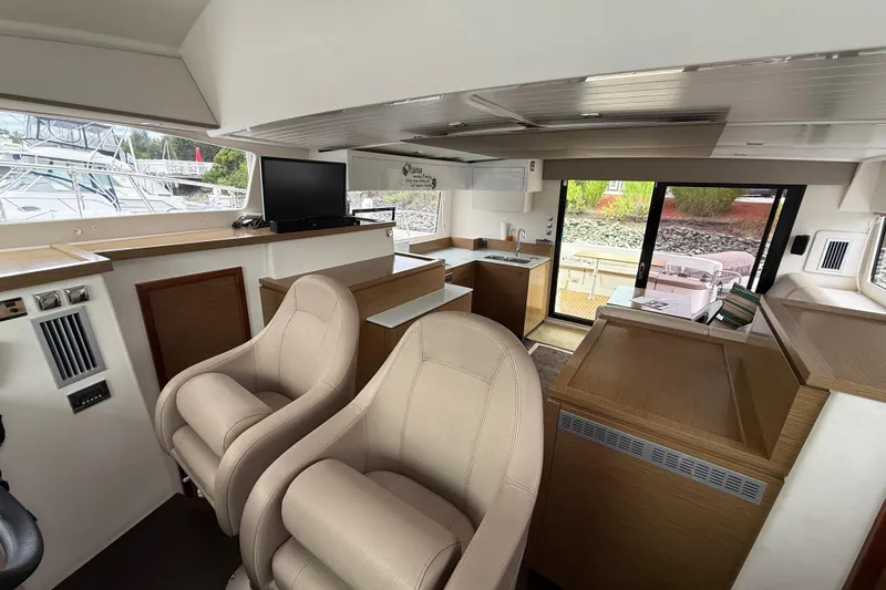 Ohana Yacht Photos Pics Interior of 2015 Fountaine Pajot Summerland 40 LC yacht, featuring modern seating and kitchen area.