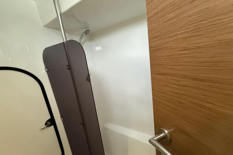 Ohana Yacht Photos Pics 2015 Fountaine Pajot Summerland 40 LC interior shower with wooden door and modern fixtures.